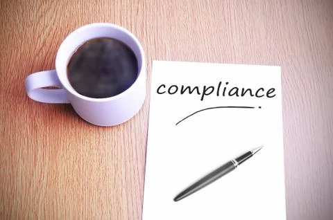 Coffee on the table with note writing compliance Stock Photos