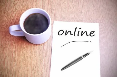Coffee on the table with note writing online Foto stock