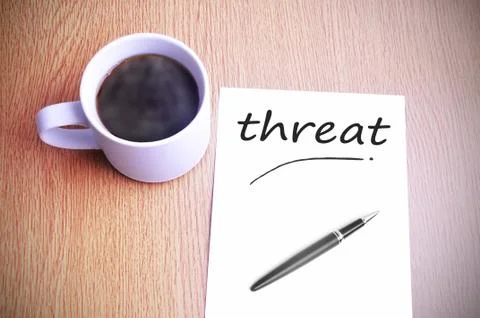 Coffee on the table with note writing threat Foto stock