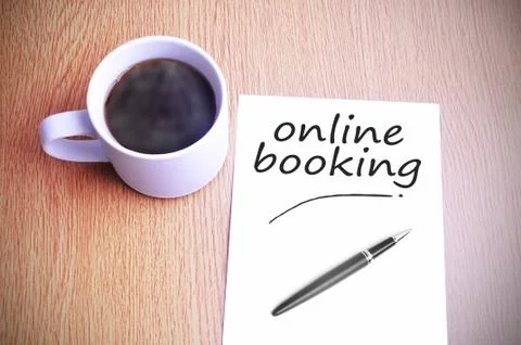 Coffee on the table with note writing writing online booking Stock Photos