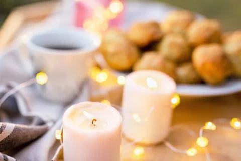 Coffee table served with coffee cup, sweet cookies and candles outdoors Stock Photos