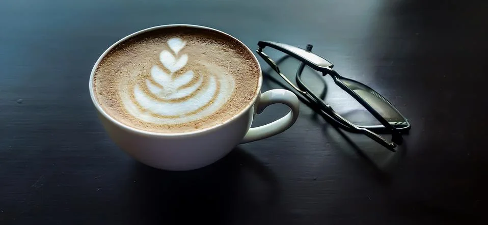 Coffee on a table with specks Stock Photos