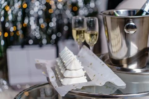 On the coffee table there is a festive cake for the New Year and champagne Stock Photos