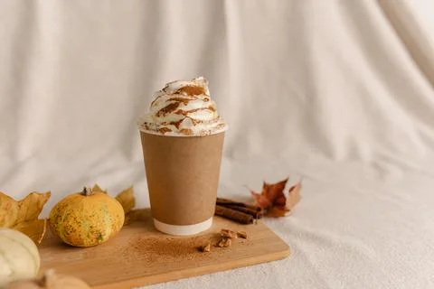 Coffee Take Away Cup in Autumn Pumpkin Set Up. Pumpkin spice latte with whipped Stock Photos