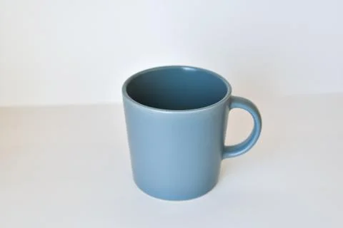 Coffee tea cup on a white table in a bright kitchen Stock Photos