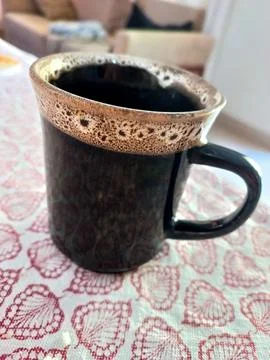 Coffee in textured mug Stock Photos