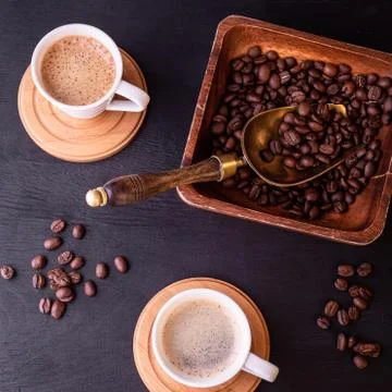 Coffee theme. Flat lay. Hot cups of coffee and plate with coffee beans. 스톡 사진