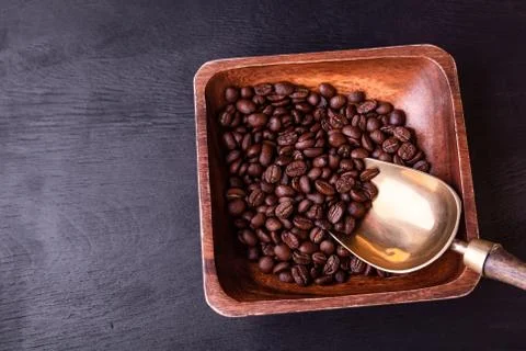Coffee theme. Plate with coffee beans on black wooden table. Foto stock
