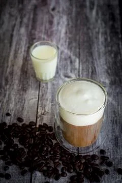 Coffee time and refreshment concept. Transparent glass of coffee with milk .. Stock Photos