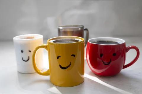 Coffee Time With Cheerful Mugs on the Table in the Morning Light Stock Photos
