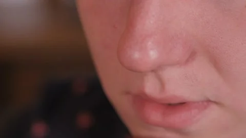 Coffee time. The man brings a mug of coffee, with foam, to his lips and takes a Stock Footage 157447329