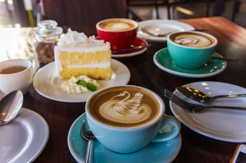 Coffee time in the wood table cafe , drink coffee and tasty cake Stock Photos