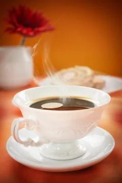 Coffee in white cup with cake in the back. coffee background. coffee concept Stock Photos