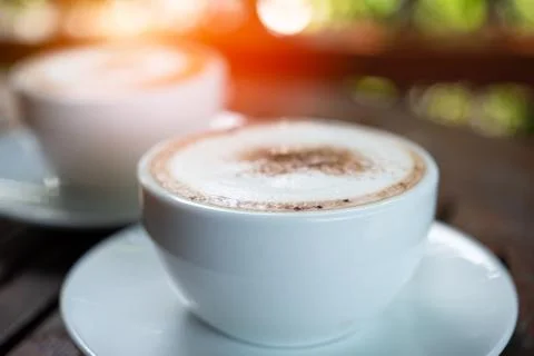 Coffee in white cup on table at coffee shop Stock Photos