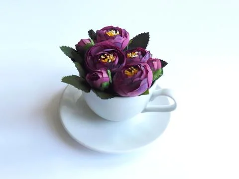 Coffee in white cup with violet peonies. Stock Photos