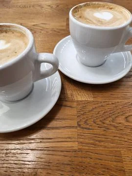 Coffee in white cups. Two white cups with coffee Stock Photos