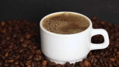 Coffee in a white mug with steam on the background of grains Stock Footage 230329818