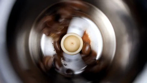 Coffee in a working grinder with individual beans spinning from above for drink Stock Footage 88515133