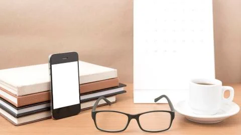 Coffee,phone,eyeglasses,stack of book and calendar Stock Photos