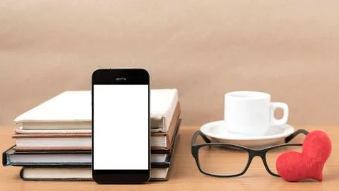 Coffee,phone,eyeglasses,stack of book and heart Stock Photos