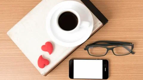 Coffee,phone,eyeglasses,stack of book and heart Stock Photos
