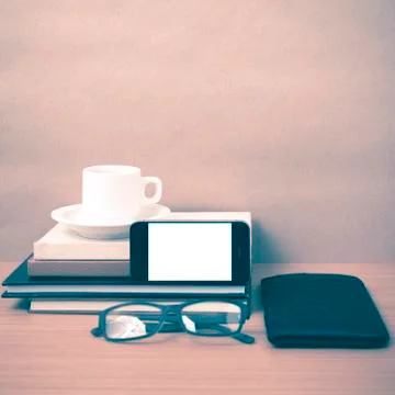 Coffee,phone,eyeglasses,stack of book and wallet 스톡 사진