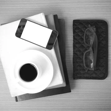 Coffee,phone,eyeglasses,stack of book and wallet 写真素材