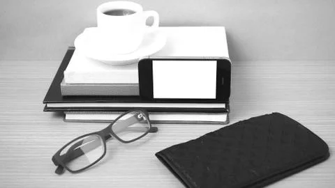 Coffee,phone,eyeglasses,stack of book and wallet Stock Photos