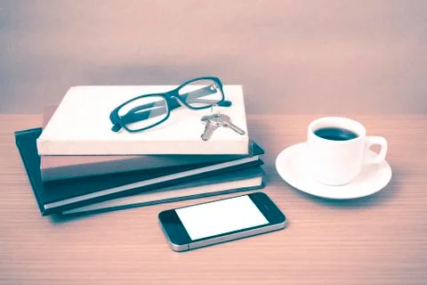 Coffee,phone,key,eyeglasses and stack of book Stock Photos