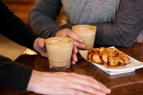 Coffees and Pastries, closeup of men's hands Stock Photos