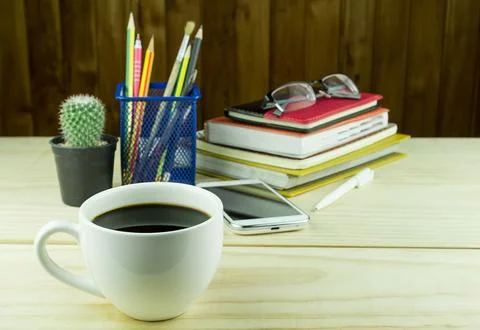 Coffee,smart phone,glasses,and stack of book on wooden Stock Photos