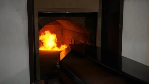The coffin is brought into the flames to be burned in the fire. Stock Footage 310211023