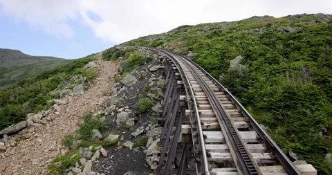 A cog railway train nearing a corner Stock Footage 251042425
