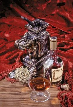 Cognac And Statuette Stock Photos
