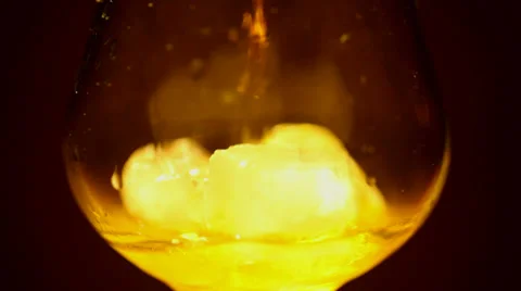 Cognac, brandy with ice is poured . Close up Stock Footage 34434447