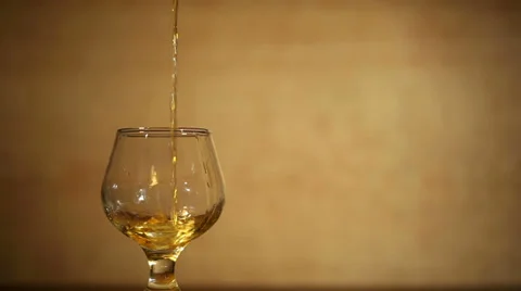 Cognac, brandy with ice is poured . Left side Video stock 34434380