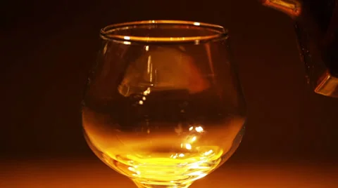 Cognac, brandy is poured from a bottle Stock Footage 34434379