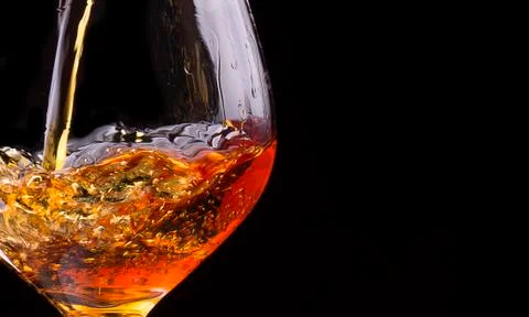 Cognac or brandy on a black Stock Photos
