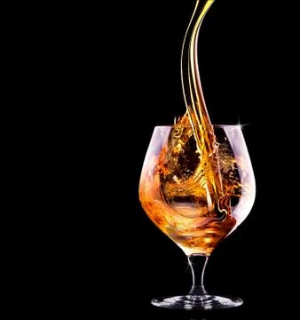 Cognac or brandy on a black Stock Photos