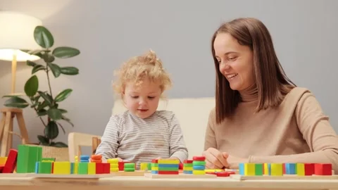Cognitive development through play. Geometric toy exploration. Toddler learning Stock Footage 256290406