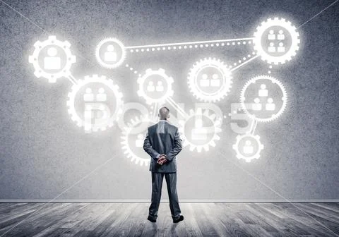 Cogwheel engine drawn on concrete wall as symbol for teamwork an Stock Photos
