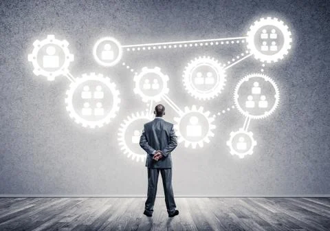 Cogwheel engine drawn on concrete wall as symbol for teamwork an Stock Photos