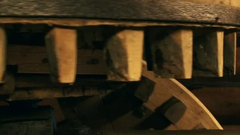 Cogwheels rotate in a 90-degree angle in an industrial corn mill - close up Stock Footage 73277015