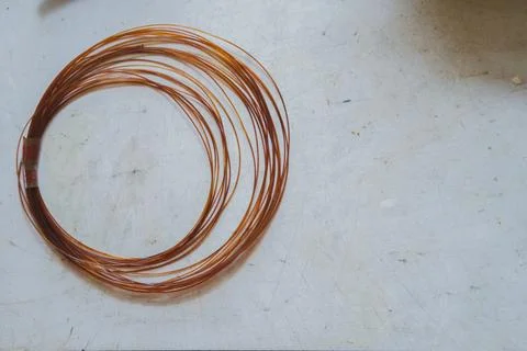 Coil of brown nylon wire on white workbench Stock Photos