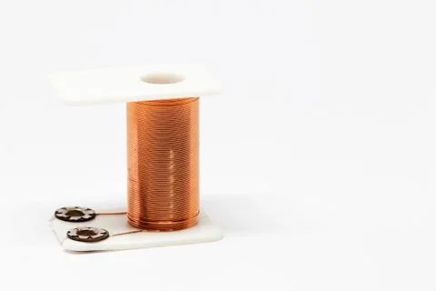 A coil with copper wire that forms part of an electric magnet Stock Photos