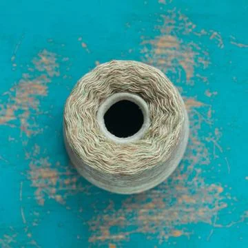 Coil with gray threads on a blue surface Stock Photos