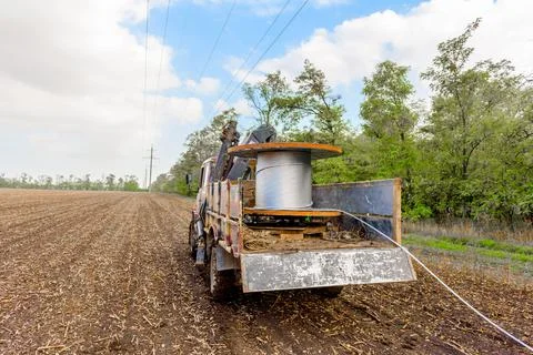 Coil with high-voltage cable mounted on wheeled truck Stock Photos