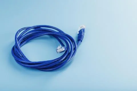 A coil of an Internet network cable for data transmission on a blue backgroun Foto stock