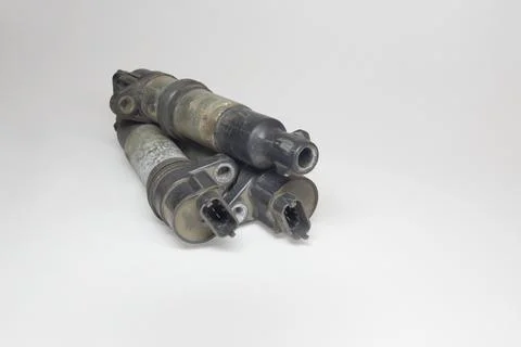 Coil on plug coils, piled. showing 3-prong blade male terminal, on white ba.. Stock Photos