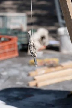 Coil of rope hangs from the structure of a construction site Stock Photos
